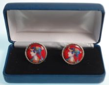 A pair of silver cufflinks having round panels having round enamelled panels decorated with