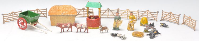 A collection of Britains toy lead cast animals and farm yard items to include two figures, a barn,
