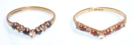 Two hallmarked 9ct gold wishbone rings, one set with alternate blue and white stones (size K.5), the
