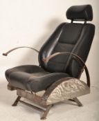 A retro 20th century car chair converted into a retro armchair in the manner of Ron Arad having