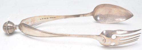 A pair of late 19th / early 20th Century Dutch silver serving tongs having an orb finial of ropes
