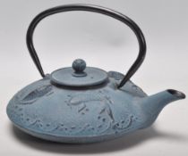 A Chinese / Japanese cast metal tea pot of round squat form having raised carp decoration with a