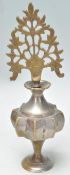 An early 20th Century Chinese brass scent bottle having a fret priced stopper and angular star body.