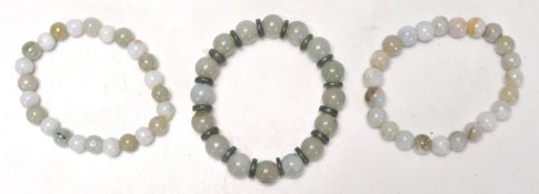 A good group of three vintage Chinese jade bead bracelets, with two similar and one having jade disc