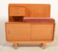 A retro mid century teak wood telephone table with velour pad seat over sliding door cupboard and