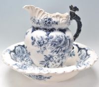 An early 20th Century Cowes china washbowl and jug having blue and white transfer printed floral