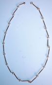 A 9ct gold and pearl ladies necklace chain. Each gold bar having pearl spacers being set to a c-