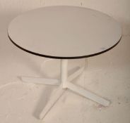 A retro mid 20th Century circular white melamine topped coffee table raised on white metal splayed