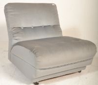 A retro 20th Century large blue button back loving chair upholstered in a light blue fabric being