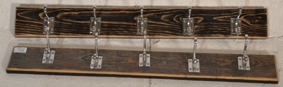 Two good pairs of five ( ten in total ) wall hanging chrome coat hooks mounted onto wooden strips.