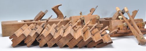 A collection of vintage wooden wood working tools to include a selection of planes including