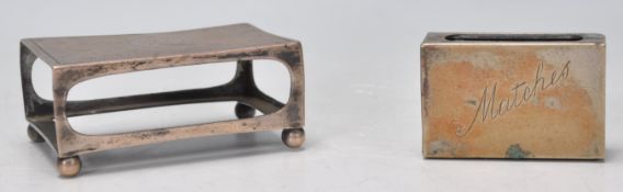 An early 20th Century silver hallmarked table match box holder having engraved decoration atop