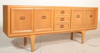 A retro mid century teak wood sideboard credenza. Raised on tapering legs with a central bank of