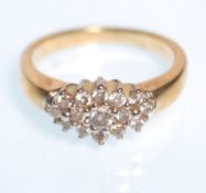 A stamped 9ct gold and diamond cluster ring having a head set with round cut diamonds. Weight 2.