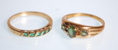 A hallmarked 9ct yellow gold ring set with five green stones. Hallmarked for Birmingham date
