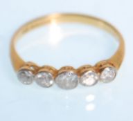 An 18ct yellow gold ladies five stone diamond ring having a five graduating diamonds of approx 0.