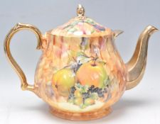 A large early to mid 20th Century teapot in the manor of Aynsley having transfer printed fruit