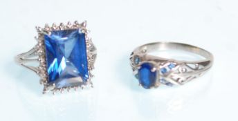 A large 9ct white gold ladies dress ring set with a large central square cut blue stone raised on