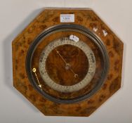 A vintage 20th Century burr walnut barometer of octagonal form having a silvered dial.  Measures