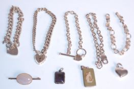 A collection of silver jewellery to include two English hallmarked curb link bracelets with heart