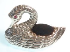 A stamped 925 silver pin cushion in the form of a swan with moulded feathers, having a blue