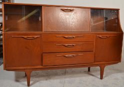 A retro 20th Century teak wood Danish influence highboard sideboard credenza, being raised on
