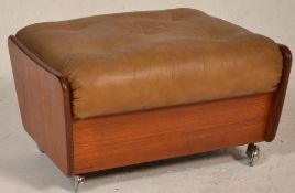 A retro teak wood 20th century G-Plan upholstered footstool ottoman. Raised on castors with teak