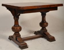 A 1930's Art Deco oak draw leaf refectory dining table being raised on splayed feet with bulbous