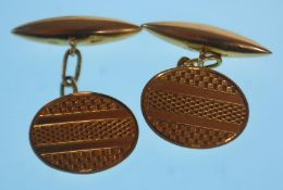 A pair of early 20th Century hallmarked 18ct gold cufflinks of oval form having engine turned