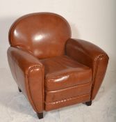 A contemporary Art Deco style brown tan leather armchair. Of French club armchair style having