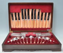 A vintage 20th Century oak cased canteen of cutlery housing a full set of Viceroy Silver Plate