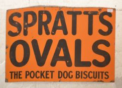 A vintage early 20th Century enamel advertising sign for ' Spratt's Ovals The Pocket Dog