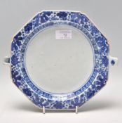 A 18th century Chinese blue and white plate warmer of octagonal form having hand painted