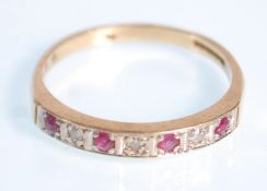 A 9ct gold ruby and diamond ring having seven stone setting of round cut ruby and diamonds.