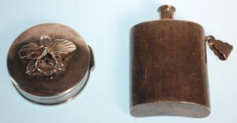 A silver hallmarked pill box embellished with a flower to the lid, of roundel form together with a