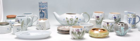 A collection of vintage Buchan Scottish stoneware pottery being hand painted with thistle patterns