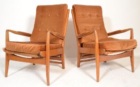 A pair of mid century teak wood Cintique armchairs