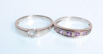 A hallmarked 9ct white gold ladies dress ring set with a central round cut light blue stone.