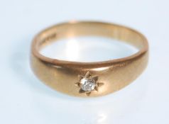 A hallmarked 9ct yellow gold ladies single stone diamond ring in a gypsy style setting. Diamond of