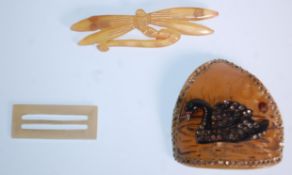 An early 20th Century 1920's early plastic celluloid brooch of triangular form with an applied black