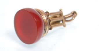 A late 19th / early 20th Century cricketing related seal fob being set with a round red stone,