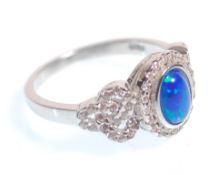 A stamped 925 silver ring having a central opal panel and CZ accent stones. Weight 3.3g. Size N.5.