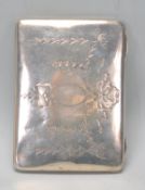 An early 20th Century silver hallmarked cigarette case having finley engraved floral and ribbon