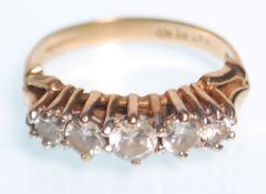 A hallmarked 9ct gold ladies ring set with five graduating round cut white stones. Weight 2.9g. Size