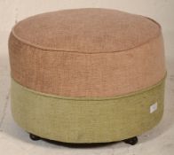 A retro mid century circular barrel foot stool pouffe in a two tone upholstered colourway of beige