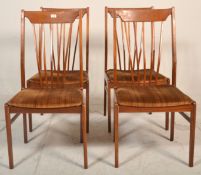 A set of 4 retro mid century teak wood Danish influence dining chairs. Raised on tapering legs