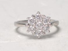 An English hallmarked platinum ladies dress ring set with round cut white stones. Hallmarked 950 for