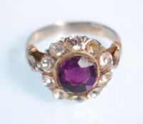 WITHDRAWN - A 14ct white gold amethyst and diamond cluster ring. The round facet cut amethyst within