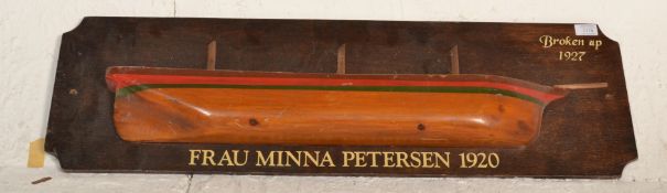 A wooden mounted half hull boat , The back panel with notation ' Broken Up 1927 ' Frau Minna