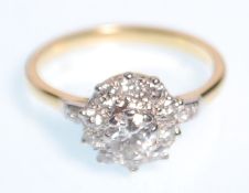 An 18ct gold  and diamond cluster ring having a central brilliant cut diamond with a halo of ten